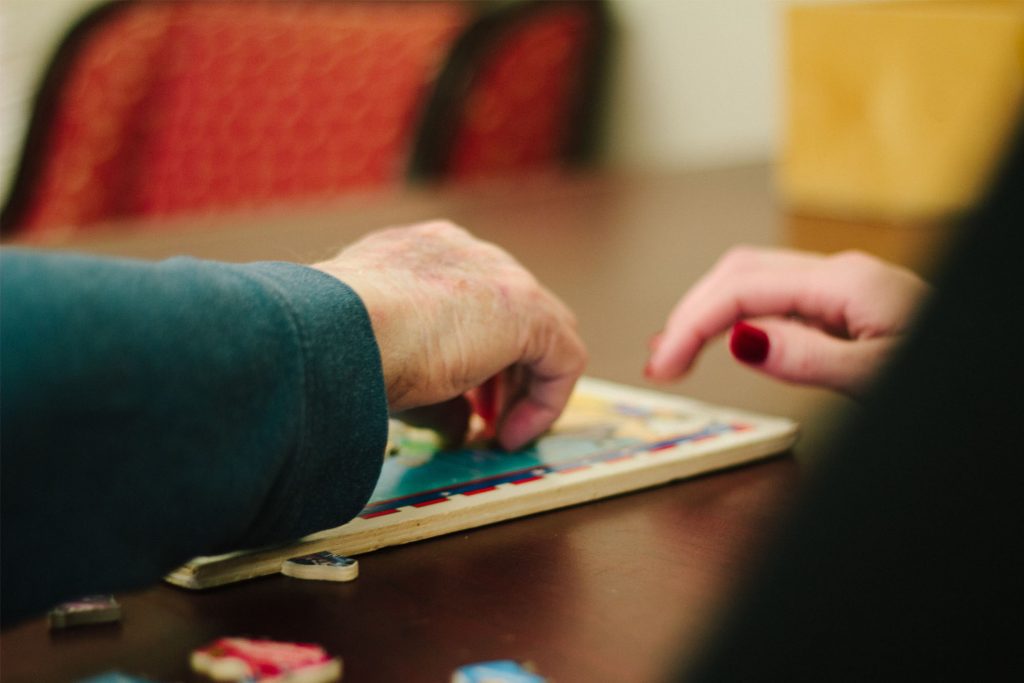 A person is doing a puzzle for memory care therapy
