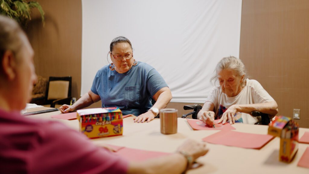 A group of women doing a craft activity at a skilled nursing nursing home