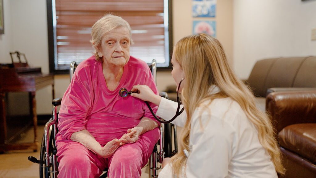 A nurse checks up on a resident at North Hills skilled nursing nursing home