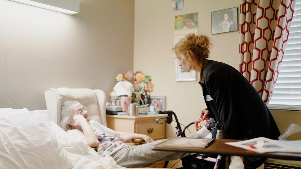 A nurse assists a woman in long term care at North Hills